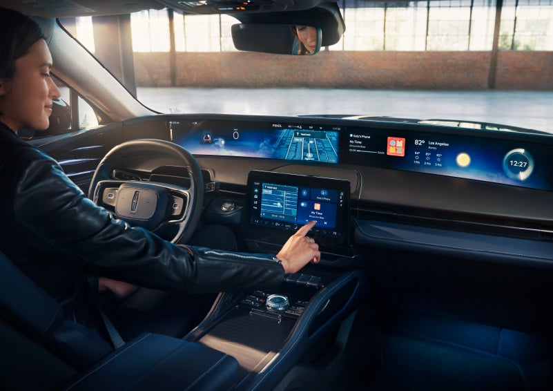 The driver of a 2024 Lincoln Nautilus® SUV interacts with the center touchscreen. | Pilson Lincoln in Mattoon IL